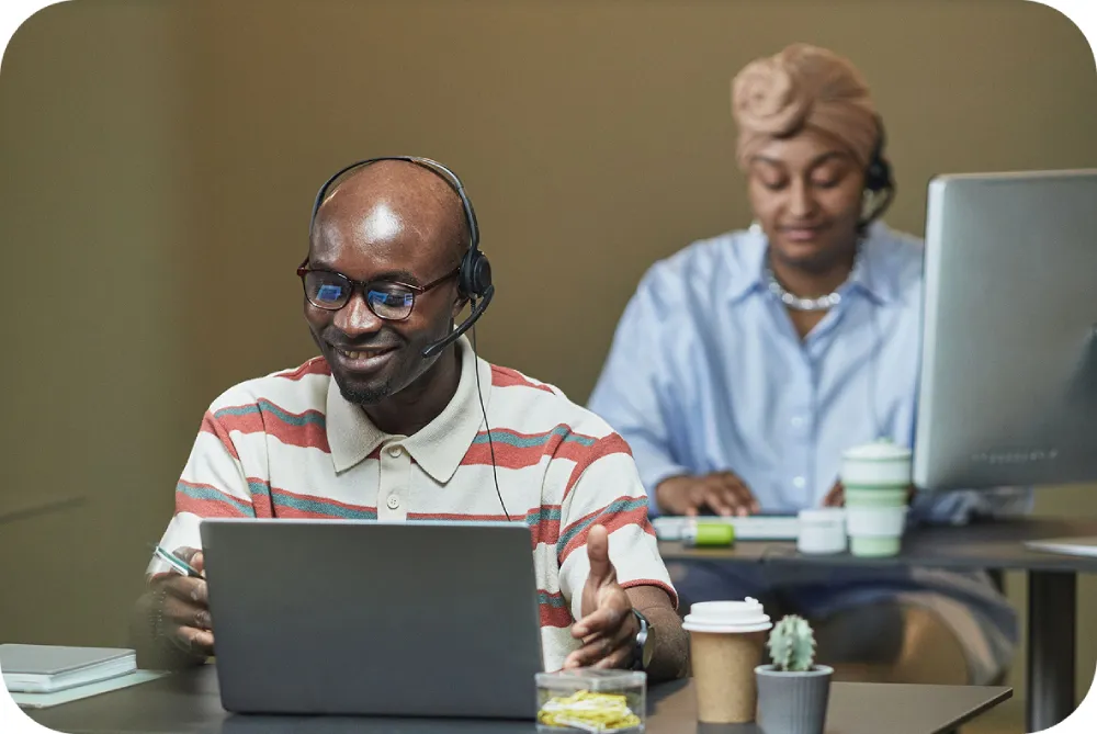 Two Kunye Cloud users working enquiries at their desks.